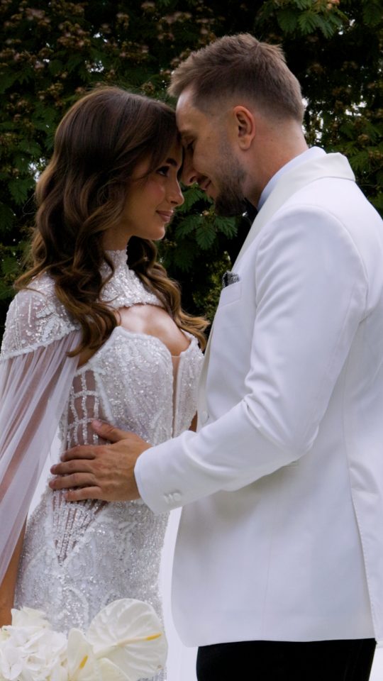 Close-up editorial wedding portrait of a bride and groom